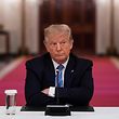 TOPSHOT - US President Donald Trump sits with his arms crossed during a roundtable discussion on the Safe Reopening of America�s Schools during the coronavirus pandemic, in the East Room of the White House on July 7, 2020, in Washington, DC. (Photo by JIM WATSON / AFP)