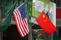 (FILES) This file photo taken on May 14, 2019 shows the US (L) and Chinese flags displayed outside a hotel in Beijing. - Chinese and US trade representatives agreed on May 8, 2020 to "create favourable conditions" for the phase one trade deal signed in January, Beijing officials said, despite recent tensions over the coronavirus pandemic. (Photo by Greg Baker / AFP)