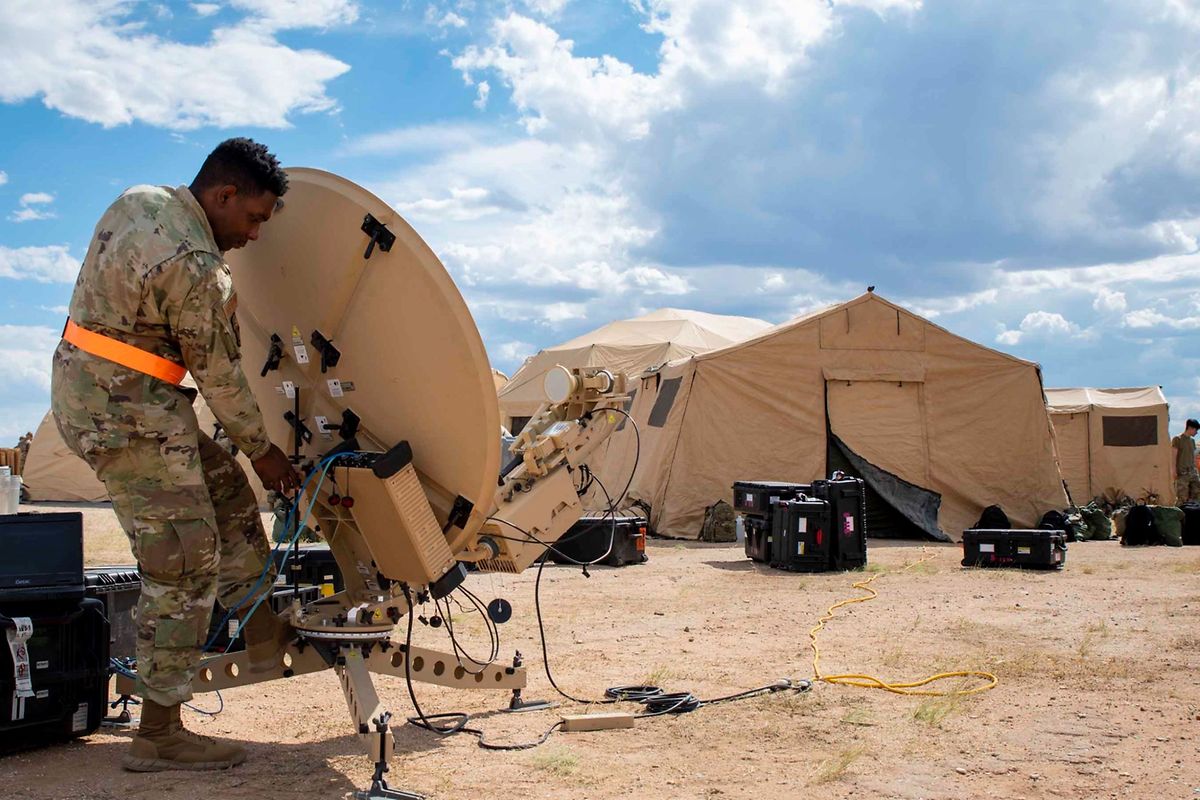 A US Air Force airman sets up a satellite in the Arizona desert during a training exercise in October 2021.