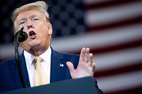 (FILES) In this file photo taken on October 11, 2019 US President Donald Trump gestures as he speaks during a "Keep America Great" rally at Sudduth Coliseum at the Lake Charles Civic Center in Lake Charles, Louisiana. - US President Donald Trump said on Saturday the next G7 summit will not be at one of his own Florida golf clubs, reversing a decision that had sparked corruption accusations. (Photo by SAUL LOEB / AFP)