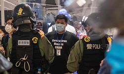 TOPSHOT - Riot police stop and search a man (C) in a shopping mall after prostesters gathered to mark one year since a group of white-clad men attacked pro-democracy protesters who were returning home from protests at the nearby Yuen Long train station, in Hong Kong on July 21, 2020. (Photo by DALE DE LA REY / AFP)