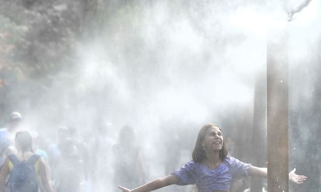 A girl cools herself as hot weather last week in the Ukrainian capital of Kiev added to the country's problems.