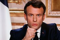 French President Emmanuel Macron is seen on a television screen as he speaks during a televised address to the nation on the outbreak of COVID-19, caused by the novel coronavirus, on March 16, 2020, in Paris. - The French president addresses the nation, with many expecting him to unveil more strict home confinement rules in a bid to prevent the virus from spreading. France has closed down all schools, theatres, cinemas and a range of shops, with only those selling food and other essential items allowed to remain open. The balance sheet of the epidemic climbed to 127 dead and 5,423 confirmed cases in France. (Photo by Ludovic Marin / AFP)
