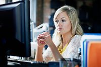 Businesswoman looking at computer monitor in office
