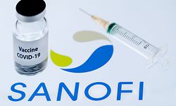 (FILES) This picture taken on November 23, 2020 shows a bottle reading "Vaccine Covid-19" next to French biopharmaceutical company Sanofi logo. - Sanofi will help Pfizer and BioNTech to produce their Covid-19 vaccine and should package more than 100 million doses for the European Union by the end of 2021, the general manager of the French laboratory announced on January 26, 2021 in an interview with Le Figaro. (Photo by JOEL SAGET / AFP)