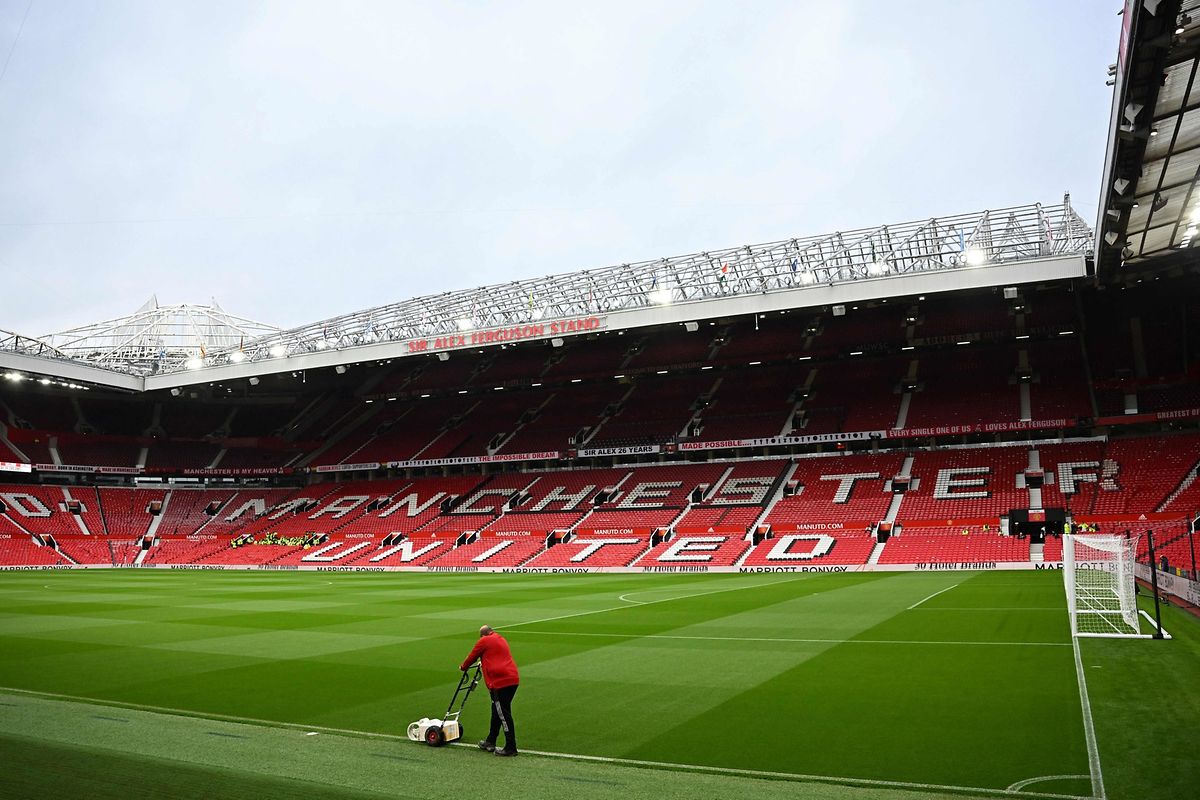 A groundsman paints the lines at Old Trafford, Manchester, August 22, 2022.