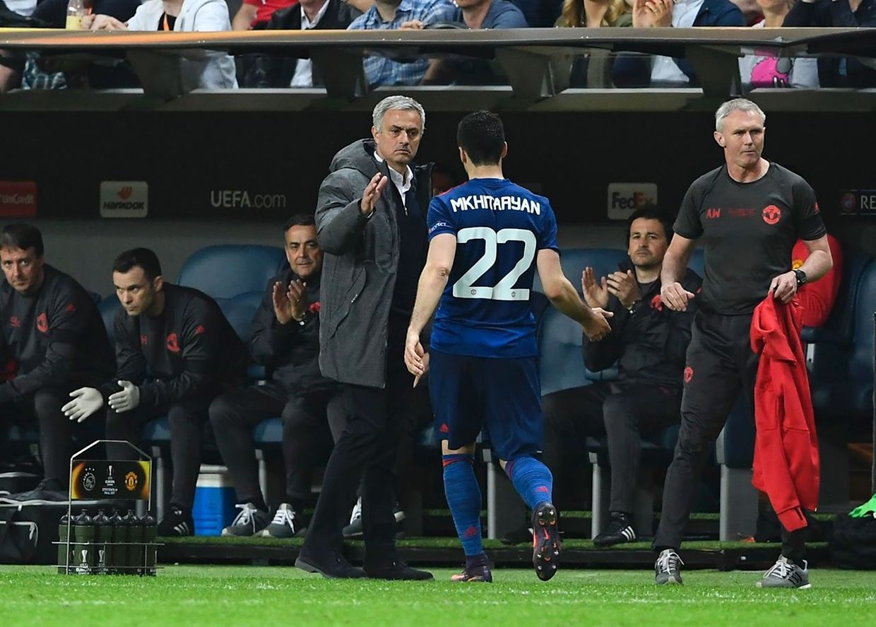 Manchester United's Armenian midfielder Henrikh Mkhitaryan (2R) shakes hands with Manchester United's Portuguese manager Jose Mourinho as he leaves the pitch during the UEFA Europa League final football match Ajax Amsterdam v Manchester United on May 24, 2017 at the Friends Arena in Solna outside Stockholm. / AFP PHOTO / Jonathan NACKSTRAND