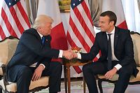(FILES) In this file photo taken on May 25, 2017 US President Donald Trump (L) and French President Emmanuel Macron (R) shake hands ahead of a working lunch, at the US ambassador's residence, on the sidelines of the NATO (North Atlantic Treaty Organization) summit, in Brussels.
A year after his march to power, French President Emmanuel Macron's reformist zeal has endeared him to part of the electorate but polls show him as still unloved by most of the country. Macron suffered a sharp drop in popularity when he began to push through changes to labour law last September that make hiring and firing easier. / AFP PHOTO / Mandel NGAN