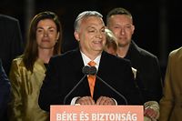 Hungarian Prime Minister Viktor Orban celebrates on stage with members of the Fidesz party at their election base, 'Balna' building on the bank of the Danube River of Budapest, on April 3, 2022. - Nationalist Hungarian Prime Minister Viktor Orban claimed a "great victory" in general election, as partial results gave his Fidesz party the lead. (Photo by Attila KISBENEDEK / AFP)