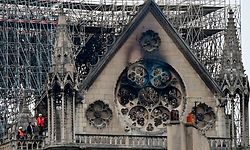 Inspectors are seen on the roof of the landmark Notre-Dame Cathedral in central Paris on April 16, 2019, the day after a fire ripped through its main roof. - A major fire broke out at the landmark Notre-Dame Cathedral in central Paris sending flames and huge clouds of grey smoke billowing into the sky, the fire service said. The flames and smoke plumed from the spire and roof of the gothic cathedral, visited by millions of people a year, where renovations are currently underway. (Photo by Lionel BONAVENTURE / AFP)