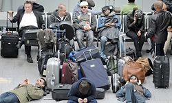 Travellers wait at the closed international Airport in Duesseldorf, Germany, Friday, April 16, 2010. Most countries in northern Europe suspended their air traffic due to ash clouds from the volcanic eruption in Iceland. (AP Photo/Martin Meissner)