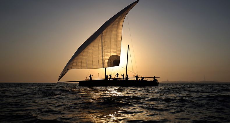 TOPSHOT - Sailors participate in the annual long-distance dhow sailing race, known as al-Gaffal, near Sir Abu Nuair island towards the Gulf emirate of Dubai, on June 3, 2022. - Around Sir Bu Nair, a teardrop-shaped island roughly 100 kilometres (60 miles) away from both Dubai and Abu Dhabi, 118 teams are racing dhows, the sailboats that have plied waters around the Arabian peninsula for centuries. (Photo by Karim SAHIB / AFP)