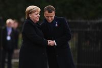 German Chancellor Angela Merkel (L) and French President Emmanuel Macron embrace as they take part in a French-German ceremony in the clearing of Rethondes (the Glade of the Armistice) in Compiegne, northern France, on November 10, 2018, as part of commemorations marking the 100th anniversary of the 11 November 1918 armistice, ending World War I. (Photo by Alain JOCARD / AFP)