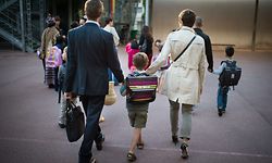 Parents take their child to school on September 3, 2013 in Paris, on the first day of school. More than 12 million pupils went back to school today in France. AFP PHOTO / MARTIN BUREAU 