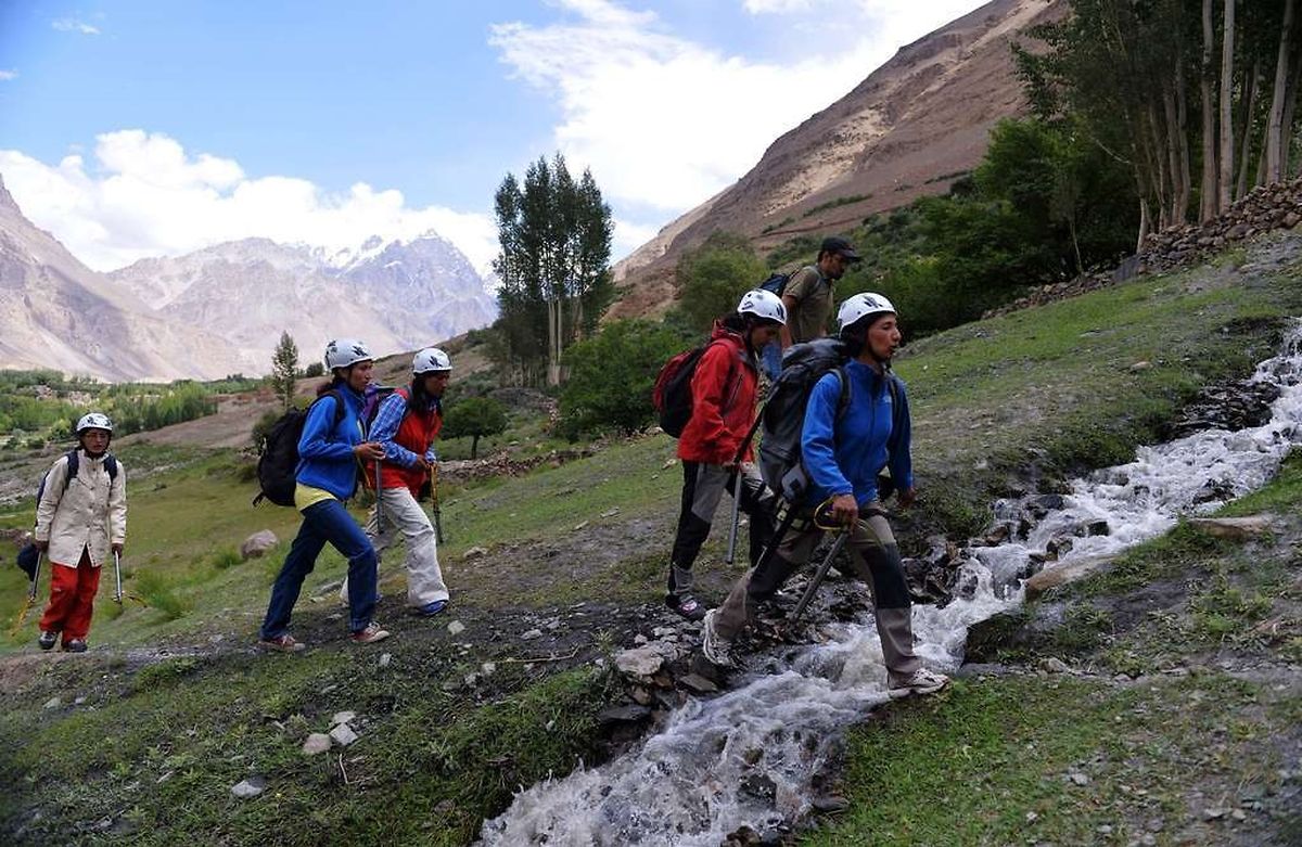 TO GO WITH Pakistan-mountaineering-women,FEATURE BY GOHAR ABBAS In this photograph taken on August 4, 2014, Pakistani students from the Shimshal Mountaineering School prepare to climb near the Shimshal village in the northern Hunza valley. Breaking taboos and pursuing jobs traditionally done by men, the first batch of women to train as high altitude guides at northern Pakistan's remote Shimshal Mountaineering School are preparing to put four years of hard study to the test. AFP PHOTO/ Aamir QURESHI
