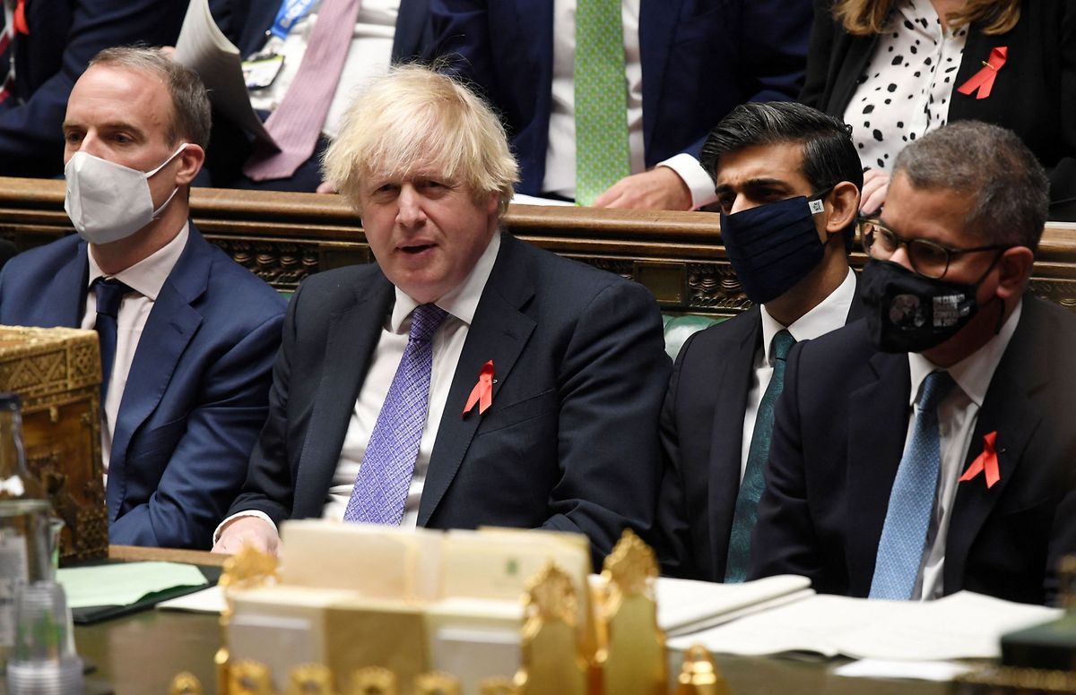 Boris Johnson reacts as he sits Dominic Raab (L), Rishi Sunak (2R) and Britain's President for COP26 Alok Sharma (R)(FILES) In this file handout photo taken on 1 December, 2021