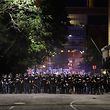 CMPD officers stand in line during a demonstration for the end of police brutaity, with The Spectrum Center behind them near uptown Charlotte, North Carolina on June 2, 2020. - US President Donald Trump said June 2, 2020, that he was now looking for a state to host the Republican National Convention later this summer, after  North Carolina said it could not do so as planned due to the coronavirus pandemic. Charlotte was the designated city to hold the Republican convention from August 24 until August 27. (Photo by Logan Cyrus / AFP)