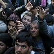 REFILE - QUALITY REPEAT Migrants who are waiting to cross the Greek-Macedonian border scuffle to get a shipment of firewood near the village of Idomeni, Greece March 6, 2016. REUTERS/Marko Djurica