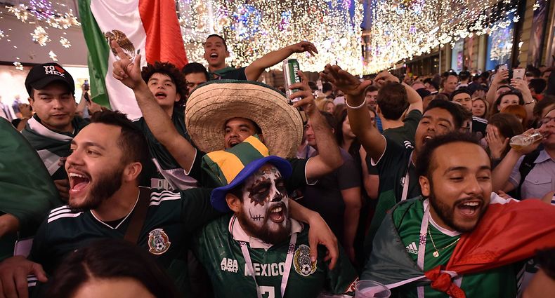 Mexico's national football team fans celebrate their team's victory outside the Kremlin on June 17, 2018, in Moscow, on the sideline of the Russia 2018 World Cup football tournament. / AFP PHOTO / Vasily MAXIMOV