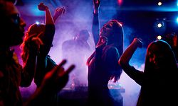 Group of dancing young people enjoying night in club