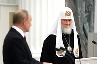 Russian President Vladimir Putin (L) and Patriarch Kirill of Moscow and All Russia attend a ceremony where the later was decorated with the highest state award in Russia, the Order of St Andrew the Apostle the First-Called, at St Catherine’s Hall of the Kremlin.