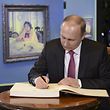 Russian President Vladimir Putin signs the guests' book as he visits an exhibition, dedicated to the 150th anniversary of artist Valentin Serov's birth, at the State Tretyakov Gallery in Moscow, Russia, January 18, 2016. REUTERS/Aleksey Nikolskyi/Sputnik/Kremlin ATTENTION EDITORS - THIS IMAGE HAS BEEN SUPPLIED BY A THIRD PARTY. IT IS DISTRIBUTED, EXACTLY AS RECEIVED BY REUTERS, AS A SERVICE TO CLIENTS.  