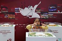 People tour the Qatar COP27 pavillon, displaying the various stadiums that will be hosting the matches of the 2022 World Cup in Qatar, at the Sharm el-Sheikh International Convention Centre, in Egypt's Red Sea resort city of the same name, during the COP27 climate conference, on November 14, 2022. (Photo by Joseph EID / AFP)