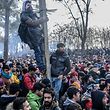 TOPSHOT - Migrants gather inside the buffer zone of the Turkey-Greece border, at Pazarkule, in Edirne district, on February 29, 2020. - Thousands of migrants stuck on the Turkey-Greece border clashed with Greek police on February 29, 2020, according to an AFP photographer at the scene. Greek police fired tear gas at migrants who have amassed at a border crossing in the western Turkish province of Edirne, some of whom responded by hurling stones at the officers. The clashes come as Greece bolsters its border after Ankara said it would no longer prevent refugees from crossing into Europe following the death of 33 Turkish troops in northern Syria. (Photo by BULENT KILIC / AFP)