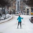 A woman skis on a snow-covered street in the city center in Halle/Saale, eastern Germany, on January 07, 2021. (Photo by JENS SCHLUETER / AFP)