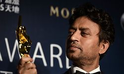 (FILES) In this file photo taken on March 27, 2014 Best Actor winner Irrfan Khan poses with his trophy during the Asian Film Awards in Macau. - Acclaimed Indian actor Irrfan Khan, whose international movie career included hits like "Slumdog Millionaire", "Life of Pi" and "The Amazing Spider-Man", has died aged just 53, his publicist said on April 29, 2020. (Photo by Philippe LOPEZ / AFP)