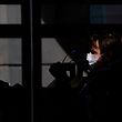 A woman wearing a protective mask takes the buss in Stockholm on April 14, 2020 amid the novel coronavirus COVID-19 pandemic. (Photo by Jonathan NACKSTRAND / AFP)