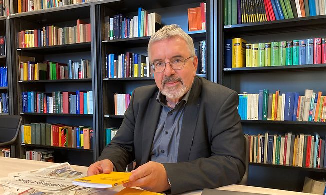 University of Luxembourg professor Heinz Sieburg sits in a library at the school's Belval campus