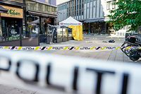 Shattered glass walls and left behind personal belongings are seen behind a police cordon on June 25, 2022, in the aftermath of a shooting outside pubs and nightclubs in central Oslo killing two people injuring another 21. - Police said a suspect had been arrested following the shootings, which occurred around 1:00 am (2300 GMT Friday) in three locations, including a gay bar, in the centre of the Norwegian capital. Police reported two dead and 14 wounded, said two weapons had been seized and are "investigating the events as a terrorist act". (Photo by Terje Pedersen / NTB / AFP) / Norway OUT