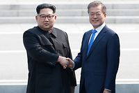 North Korea's leader Kim Jong Un (L) and South Korea's President Moon Jae-in shake hands at the Military Demarcation Line that divides their countries at Panmunjom on April 27, 2018.
The two men briefly stepped back over the line into the North before walking to the Peace House building on the southern side of the truce village of Panmunjom for the summit -- only the third of its kind since hostilities ceased in 1953. / AFP PHOTO / Korea Summit Press Pool / Korea Summit Press Pool