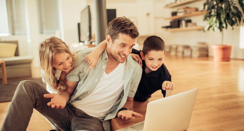 Close up photo of father and kids using laptop