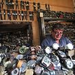 Watch repairman Youssef Abdelkarim sits at his workshop on Rasheed Street in Iraq's capital Baghdad on December 9, 2020. - Youssef Abdelkarim's storefront on one of Baghdad's most historic streets is a time capsule -- literally. Thousands of wristwatches fill the tiny shop, where three generations have repaired Iraq's oldest timepieces. Abdelkarim began fixing watches at the age of 11, after the death of his paternal grandfather, who opened the store in the 1940s. (Photo by AHMAD AL-RUBAYE / AFP)