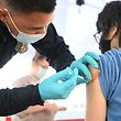 (FILES) In this file photo taken August 23, 2021, Brandon Rivera, a Los Angeles County emergency medical technician, gives a second dose of the Pfizer-BioNTech Covid-19 vaccine to 16-year-old Aaron Delgado in a pop-up vaccination clinic in the Arleta neighborhood of Los Angeles, California.  - On October 29, 2021, the United States authorized the Pfizer Covid vaccine for children aged 5 to 11 after an expert committee found that its benefits outweighed the risks.  (Photo by Robyn Beck / AFP)