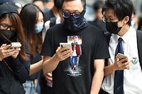 Masked protesters gather outside the High Court premises in support of activist Edward Leung, jailed for taking part in the 2016 Mongkok riots, during an appeal hearing for his period of sentence in Hong Kong on October 9, 2019. - Leading independence activist Leung was jailed for six years on June 2018 for his involvement in the 2016 Lunar New Year riots in Hong Kong's Mongkok district, then one of the city's worst protest violence in decades, as semi-autonomous Hong Kong has been battered by four months of increasingly violent pro-democracy protests sparked by opposition to a now-scrapped bill allowing extraditions to China. (Photo by Mohd RASFAN / AFP)