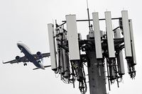 A cellular tower stands as an JetBlue Airbus A321neo airplane lands at Los Angeles International Airport (LAX) in the Lennox neighborhood of Los Angeles, California on January 19, 2022. - Telecom giants AT&T and Verizon began 5G cell phone data service in the United States Wednesday without major disruptions to flights after the launch of the new wireless technology was scaled back. (Photo by Patrick T. FALLON / AFP)