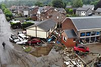 Cars and debris is piled up at in a residential area destroyed by recent flood waters in Trooz on 16 July 2021. - The death toll from devastating floods in Europe soared to at least 126 on Friday, most in western Germany where emergency responders were frantically searching for missing people. (Photo by ERIC LALMAND / BELGA / AFP) / Belgium OUT