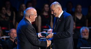All smiles, but that may change: Portuguese Foreign Minister Augusto Santos Silva handing over the keys to the EU to Slovenia's Prime Minister Janez Jansa on Friday