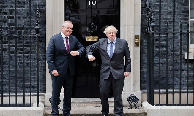 Britain's Prime Minister Boris Johnson (R) greets Australia's Prime Minister Scott Morrison (L) on the steps of 10 Downing Street in London on June 14, 2021