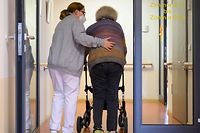 A elderly care nurse helps a resident in the retirement home St. Barbara of German welfare organisation in Stuttgart, southern Germany, on November 17, 2020, amid the new coronavirus COVID-19 pandemic. (Photo by THOMAS KIENZLE / AFP)