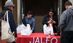 WASHINGTON, DC - MARCH 17: People purchase carry-out lunches out of the back door of celebrated Chef Jos� Andres' Jaleo restaurant in response to the novel coronavirus March 17, 2020 in Washington, DC. Andres, whose World Central Kitchen has set up disaster response kitchens to feed people in Puerto Rico, Indonesia, Mozambique, Guatemala and other countries, converted all his Washington restaurants into 'community kitchens' in response to the COVID-19 outbreak.   Chip Somodevilla/Getty Images/AFP
== FOR NEWSPAPERS, INTERNET, TELCOS & TELEVISION USE ONLY ==