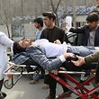 An injured man is brought on a stretcher to an ambulance following a gun attack during an event to mark the 25th anniversary of death of Shiite leader Abdul Ali Mazari, In Kabul on March 6, 2020. - At least 27 people were killed in an attack on a political rally in Kabul on March 6, officials said, in the deadliest assault in Afghanistan since the US signed a withdrawal deal with the Taliban. (Photo by STR / AFP)