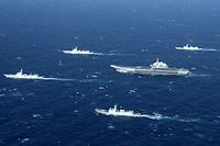 (FILES) This aerial file photo taken on January 2, 2017 shows a Chinese Navy formation, including the aircraft carrier Liaoning (C), during military drills in the South China Sea. - US Secretary of State Mike Pompeo said on July 13, 2020 the United States would treat Beijing's pursuit of resources in the dispute-rife South China Sea as illegal, ramping up support for Southeast Asian nations and triggering a furious response from Beijing. (Photo by STR / AFP) / China OUT
