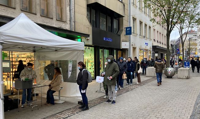 People line up outside a pharmacy in central Luxembourg for a rapid test to detect the Covid-19 virus