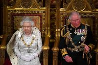 Britain's Queen Elizabeth II (L) sits with Britain's Prince Charles, Prince of Wales (R) on the Sovereign's throne to deliver the Queen's Speech at the State Opening of Parliament in the Houses of Parliament in London on October 14, 2019. - The State Opening of Parliament is where Queen Elizabeth II performs her ceremonial duty of informing parliament about the government's agenda for the coming year in a Queen's Speech. (Photo by Victoria Jones / POOL / AFP)