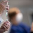 A nurse prepares a dose of the Pfizer/BioNTech Covid-19 vaccine at a vaccination centre set up at the exhibition hall in Nantes, western France, on April 9, 2021. (Photo by LOIC VENANCE / AFP)