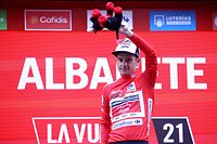 Team Trek's French rider Kenny Elissonde celebrates on the podium wearing the red jersey of the general ranking leader during the 5th stage of the 2021 La Vuelta cycling tour of Spain, a 184.4-km race from Tarancon to Albacete, on August 18, 2021. (Photo by JOSE JORDAN / AFP)
